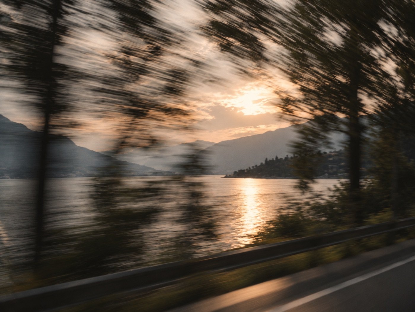 Lakeside road at golden hour seen through a blur of motion
