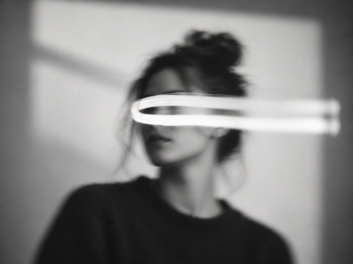 Black and white portrait with a streak of light across it